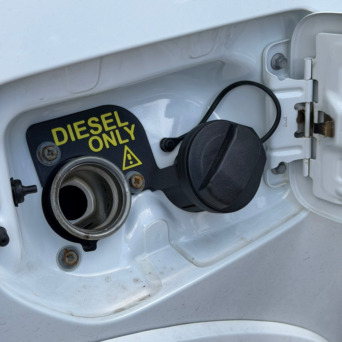 GWM Cannon Fuel Cap Holder with cap clipped in while refuelling | SimuVerse.AU